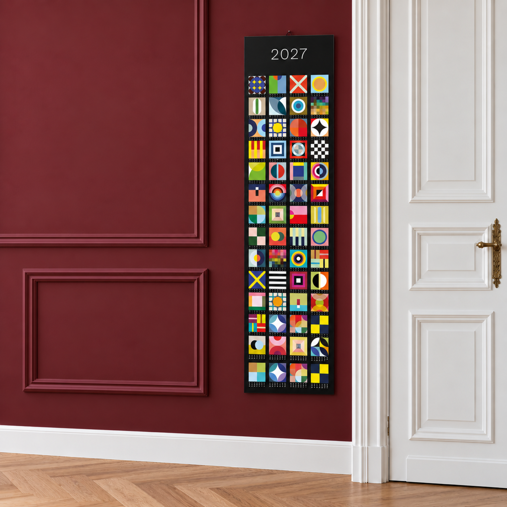 Calendario a banner verticale 2027 con 52 quadrati colorati e astratti su sfondo scuro. Ogni casella rappresenta una settimana del calendario con forme geometriche e motivi vivaci propri. L'anno 2027 è ben visibile in alto.
