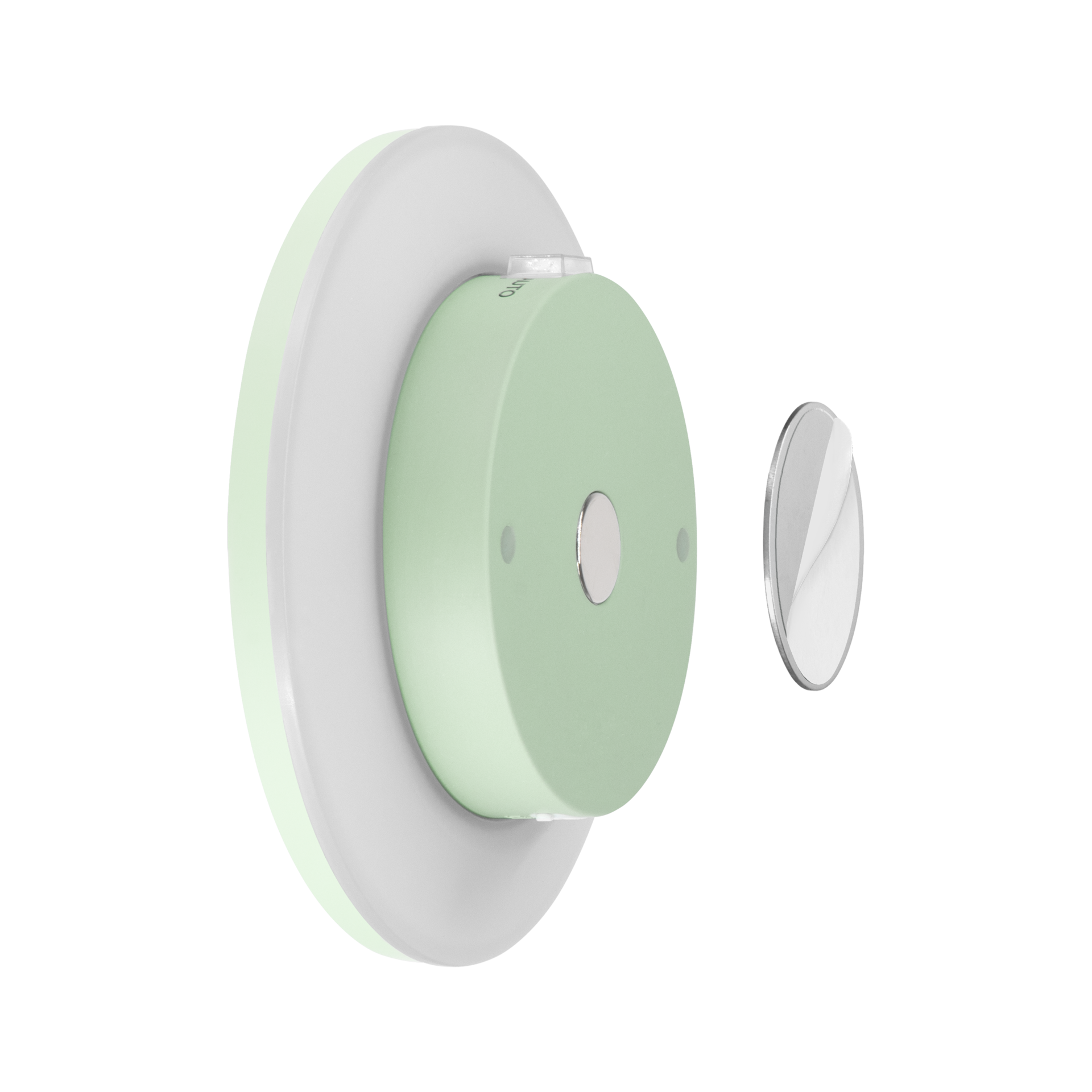 Applique murale ronde vert menthe avec bord éclairé gris clair, fixée au mur. Au centre, bouton ovale argenté de réglage de l'intensité. À droite, disque magnétique argenté séparé, film de protection partiellement retiré.