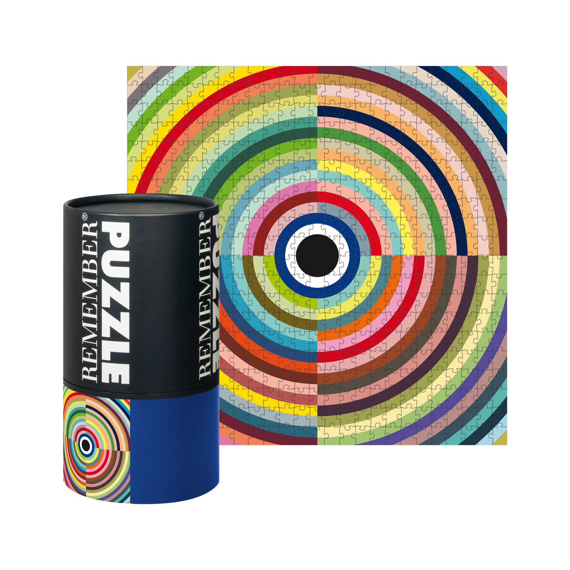 REMEMBER Puzzle in zylindrischer schwarzer-blauer Verpackung. Das Mantra-Puzzle zeigt ein Quadrat aus vielen farbigen konzentrischen Kreisen. In der Mitte ein schwarzer Punkt mit weißem Ring, außen Bögen in Blau, Rot, Grün, Gelb.